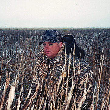 Rennie Gay in camouflage in a field of cut stalks