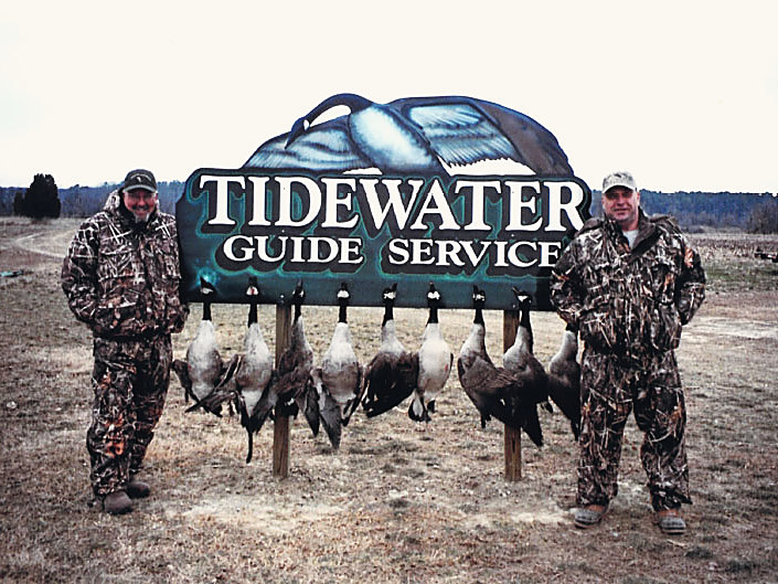 Two hunters, and a rail full of Canada geese